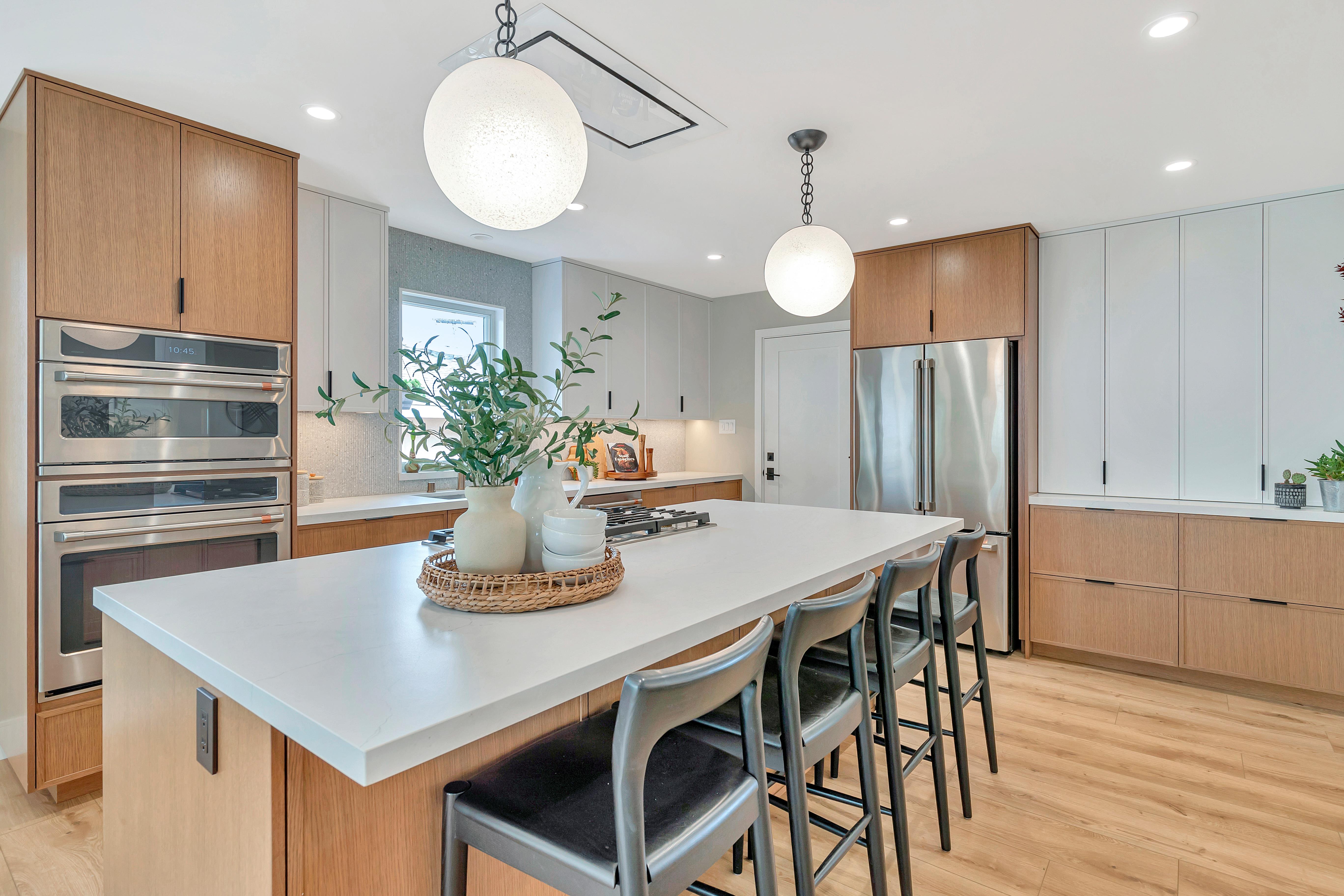 Modern kitchen remodel with large island and wood cabinetry